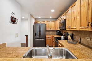 Enjoy cooking in this well-equipped kitchen with a refrigerator, microwave, and coffee maker.