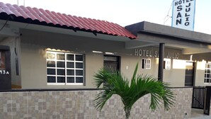 A building with a tiled facade, a red roof, and a sign reading "HOTEL JULIO". - Hotel San Julio (Celestún)