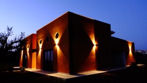 A modern building with a flat roof, large windows, and a symmetrical facade. - Locanda degli Scrittori (Agrigento)