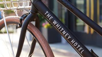 A close-up of a bicycle with "THE WHITNEY HOTEL" written on the frame.