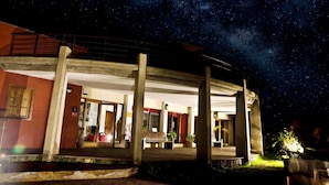 Un bâtiment doté d’un espace extérieur abrité, de colonnes et d’un banc.