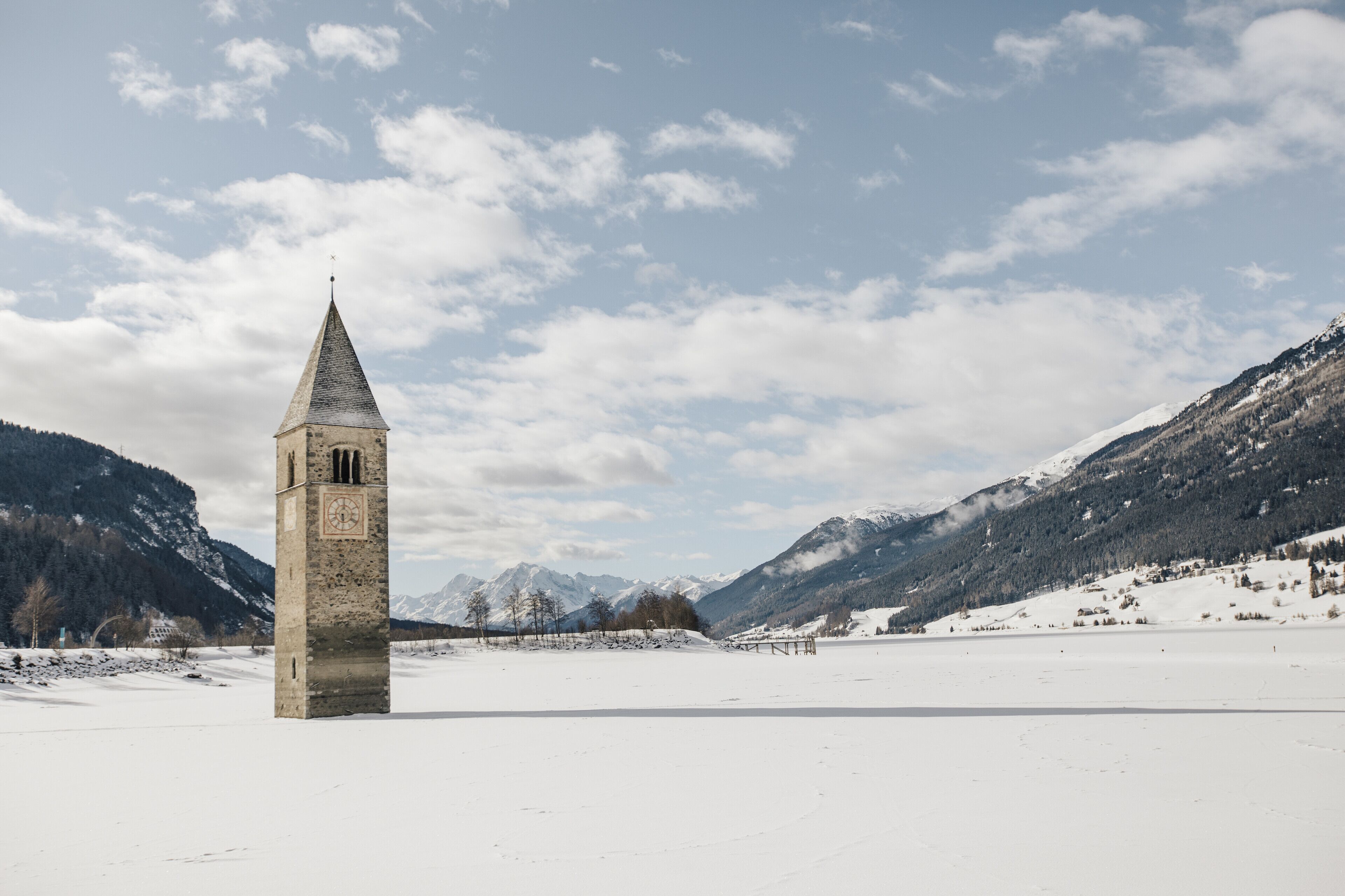 A snow-covered landscape with a prominent tower in the foreground.