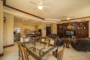 Relax in this inviting living area with a dining table, comfortable sofa, and kitchenette.