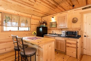 Nicely-equipped kitchen featuring a refrigerator, microwave, and coffeemaker