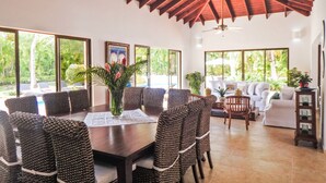 A spacious dining area with a high ceiling and large windows, offering views of the outdoors. - Villa Toscano by Casa de Campo Resort & Villas (La Romana)