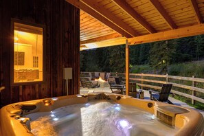 A hot tub with a wooden deck and outdoor seating area.