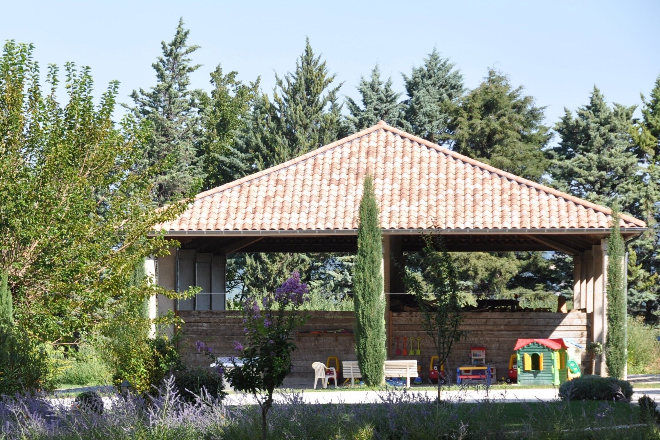 A building with a tiled roof and a covered patio area.