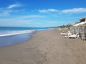 On the beach, sun-loungers, beach towels