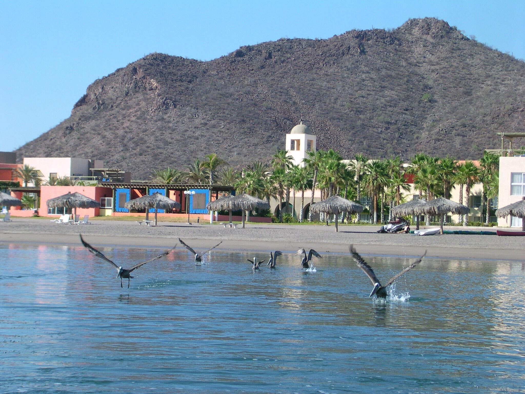 Rannalla, aurinkotuoleja, rantapyyhkeitä