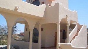 A modern building with a unique architectural design, featuring a prominent staircase and arched structures.