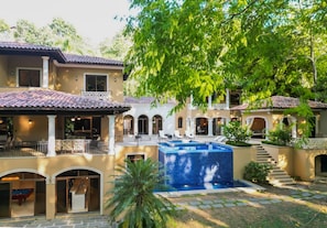 A multi-story house with a swimming pool, outdoor seating, and a covered patio area. - Los Suenos Luxury Villas by Stay in Costa Rica (Jacó, Costa Rica)