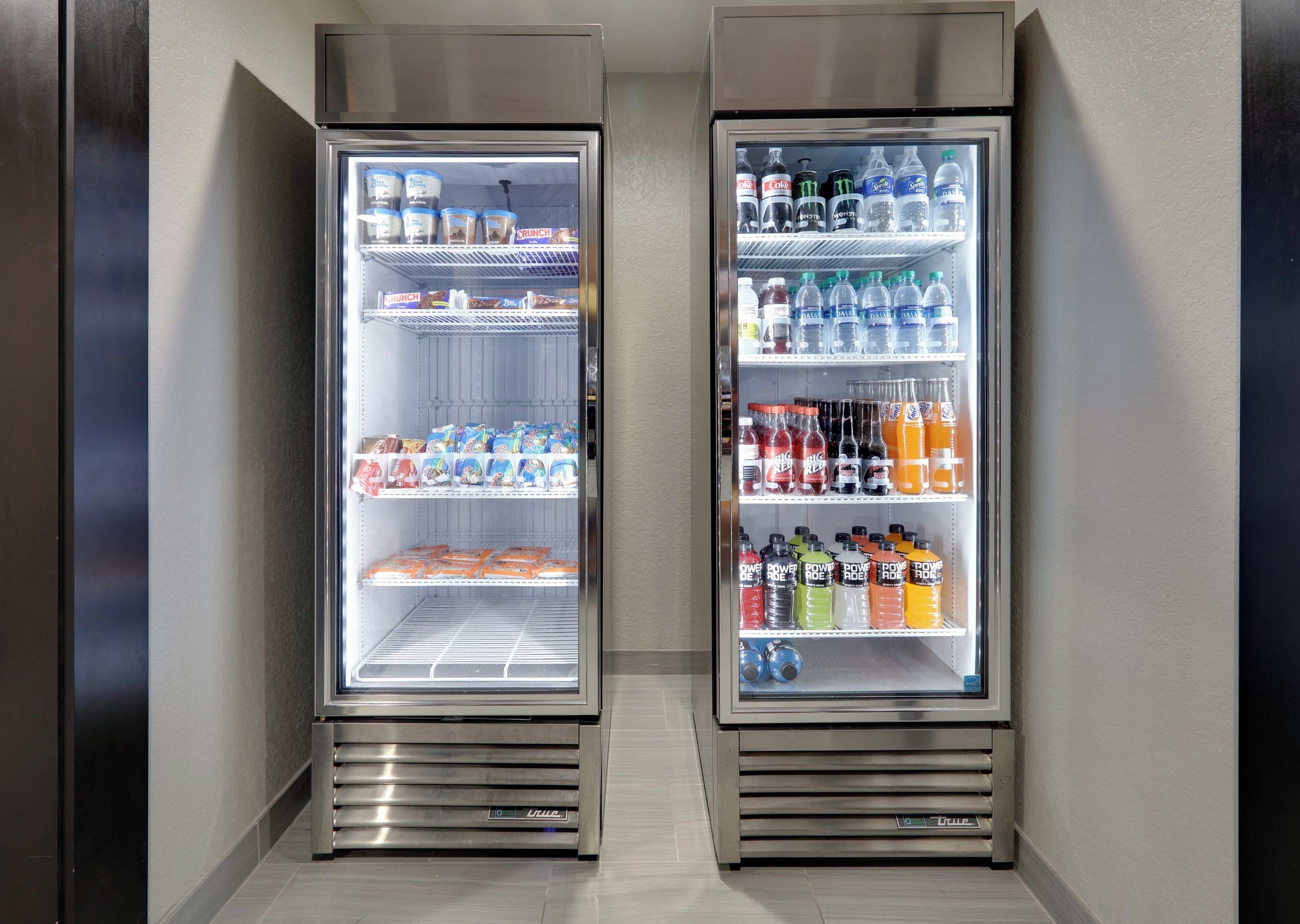 Two side-by-side beverage dispensers stocked with various drinks and snacks.