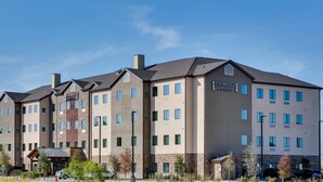 A Staybridge Suites hotel with a modern design, featuring multiple floors and a prominent sign. - Staybridge Suites San Antonio - Schertz  by IHG (Schertz)