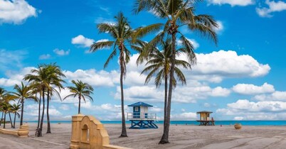 Modern Hollywood Beach villa with a private heated saltwater pool, hot tub, and spacious family-friendly layout. Just 1 mile from the ocean & Broadwalk, featuring a full kitchen, open living areas, and tropical outdoor lounge spaces.