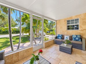 A spacious living area with a large window, a sofa, and a coffee table.