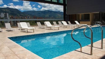 Outdoor pool, open 9:00 AM to 6:00 PM, pool umbrellas, pool loungers