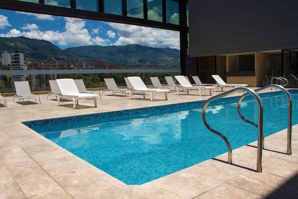 Outdoor pool, open 9:00 AM to 6:00 PM, pool umbrellas, pool loungers