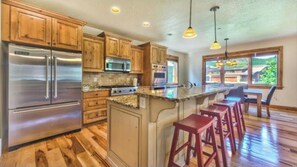 Enjoy cooking in this well-equipped kitchen with a large island and bar stools.