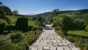 A stone pathway leading to a scenic overlook with a view of the landscape and distant horizon.