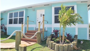 A light blue house with a white door, wooden steps, and a rope barrier. - Island Life at its best (Key Largo)