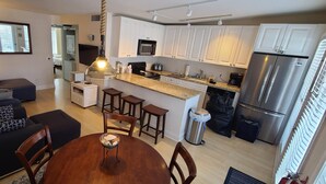 A modern apartment with a living room, dining area, and kitchen. - Cape May Condo Getaway w/ Rooftop Deck, Onsite Parking, 1/2 Block to the Beach (Cape May)
