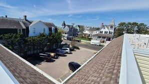 A residential street with houses, parked cars, and a clear sky. - Cape May Condo Getaway w/ Rooftop Deck, Onsite Parking, 1/2 Block to the Beach (Cape May)