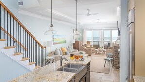 A spacious kitchen with a granite countertop, a built-in dishwasher, and a large island. - Oceanfront with Endless Ocean Views (Folly Beach)