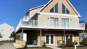 A two-story house with a balcony, a garage, and a front porch.