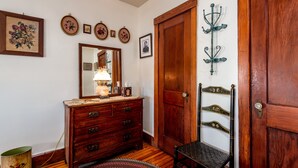 A room with a wooden dresser, a mirror, a chair, and a door. -  Lincoln Quarters, 2nd floor,  Only 2 blocks to the center of town. (Gettysburg)