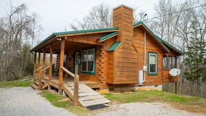 A wooden cabin with a porch, a chimney, and a satellite dish. - Honeymoon/couples Retreat -  Private Custom Built Log Cabin - Wi-fi (Sevierville)
