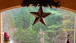 A window with a star decoration, a Santa figurine, and a Christmas tree model. - SPACIOUS FAMILY RETREAT NEAR ALL THE FUN! STUNNING VIEW, EASY ACCESS. (Sevierville)