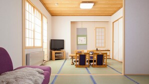 A traditional Japanese-style room with tatami flooring, a television, a tatami mat table with chairs, and a shoji screen. - Shibetsugawa Onsen Puruke no Yakata Hotel Kawabata (Shibetsu)