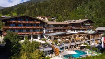 Experience the charm of the Wanderhotel Gassner, set amidst lush greenery and majestic mountains.