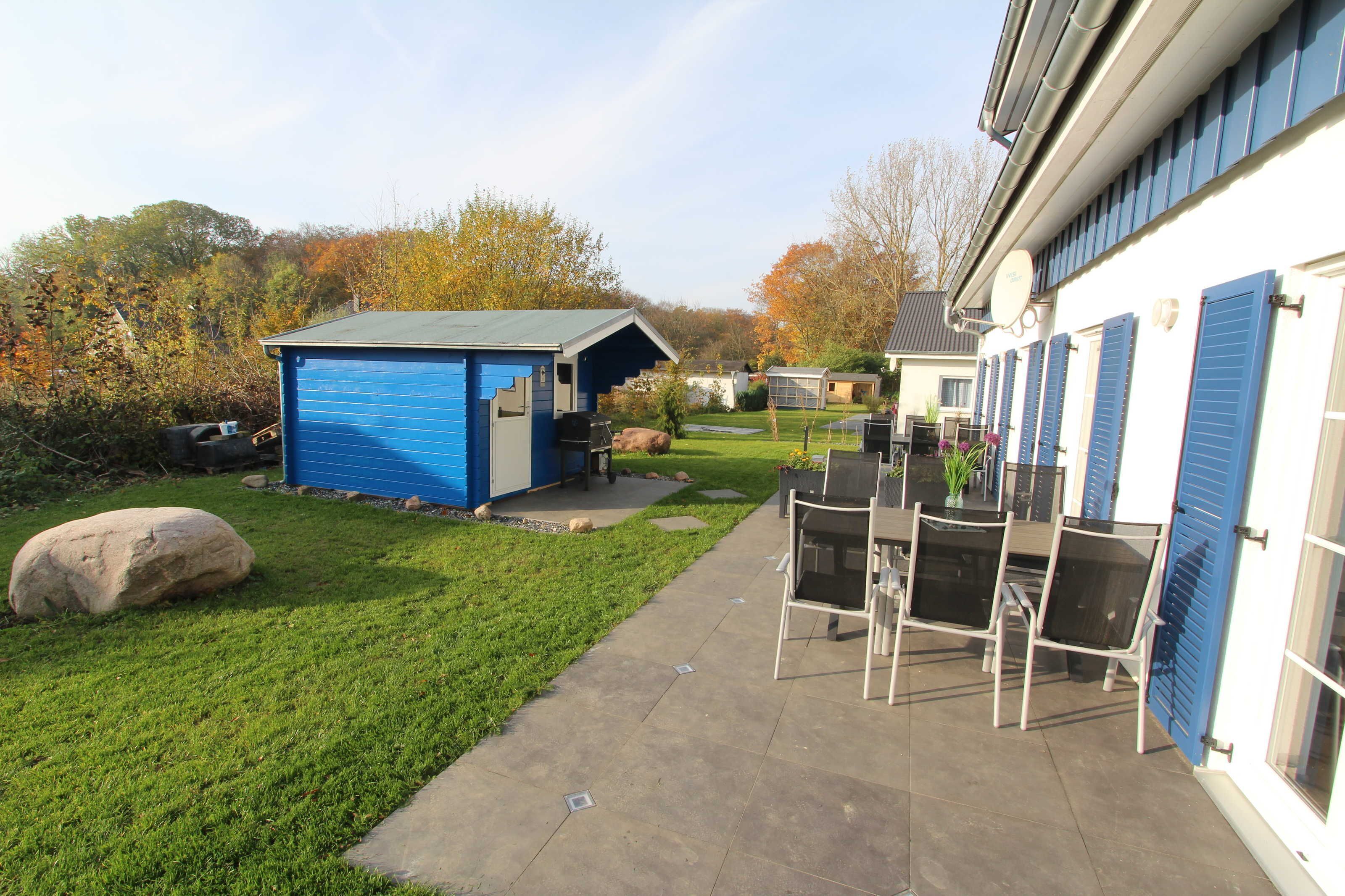 A patio area with outdoor furniture and a shed.