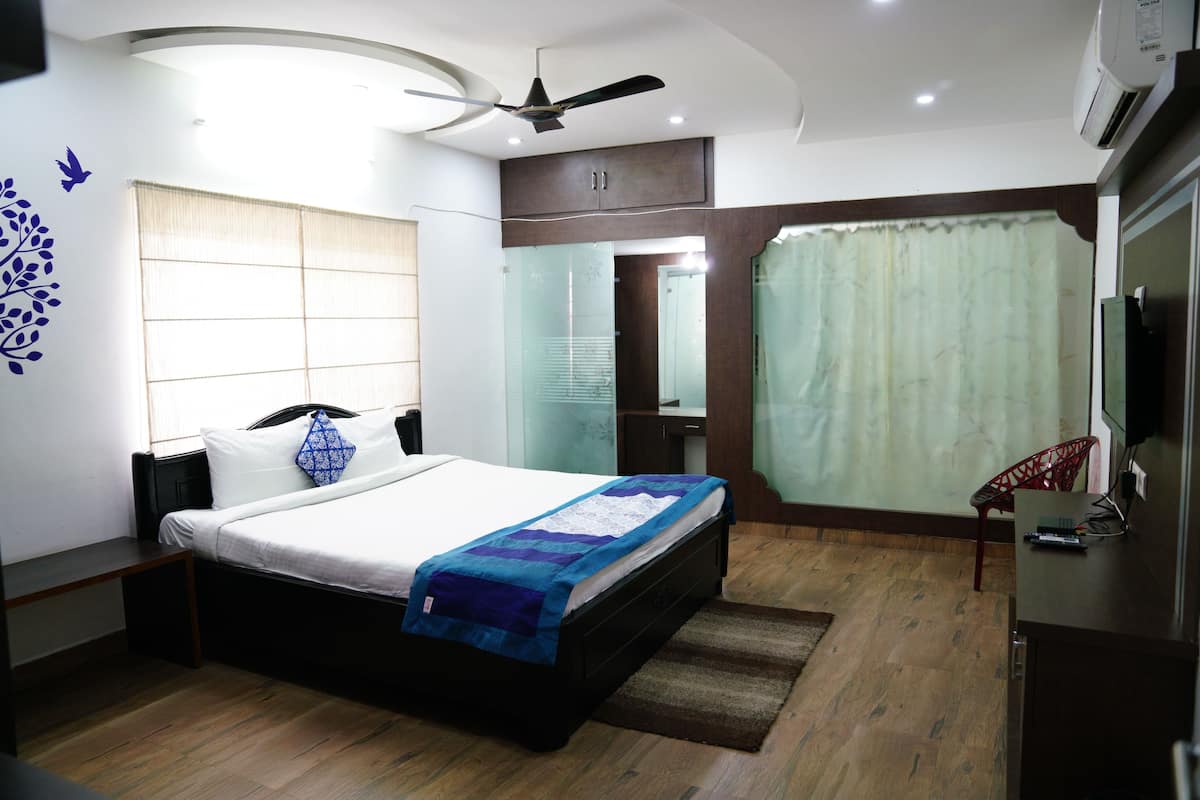 A modern bedroom with a bed, bedside table, and a ceiling fan.