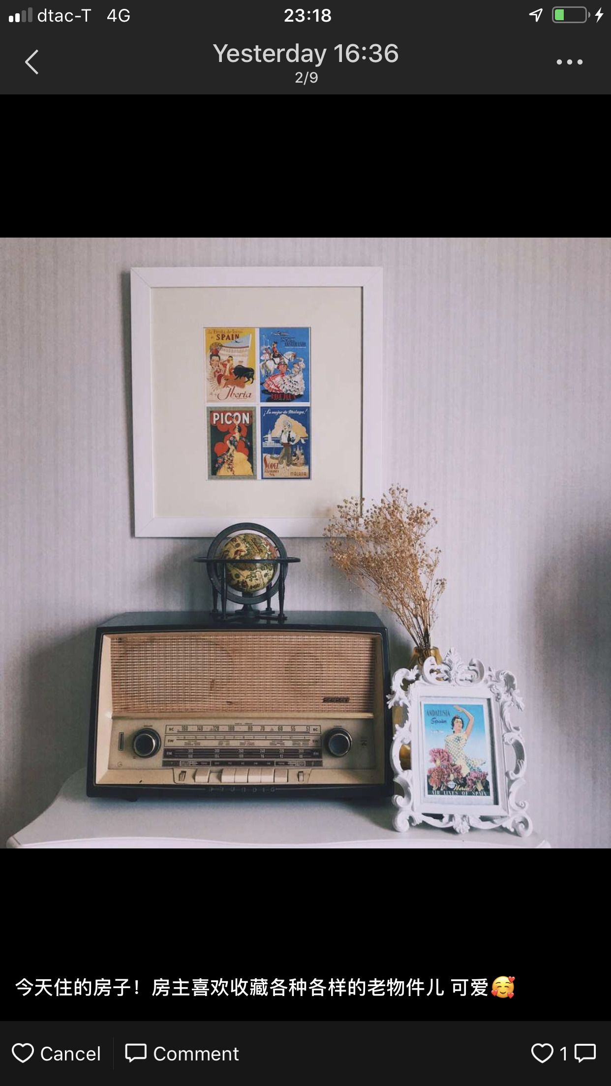 A framed vintage radio and posters on a shelf.