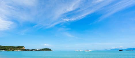 On the beach, white sand, sun loungers, beach umbrellas