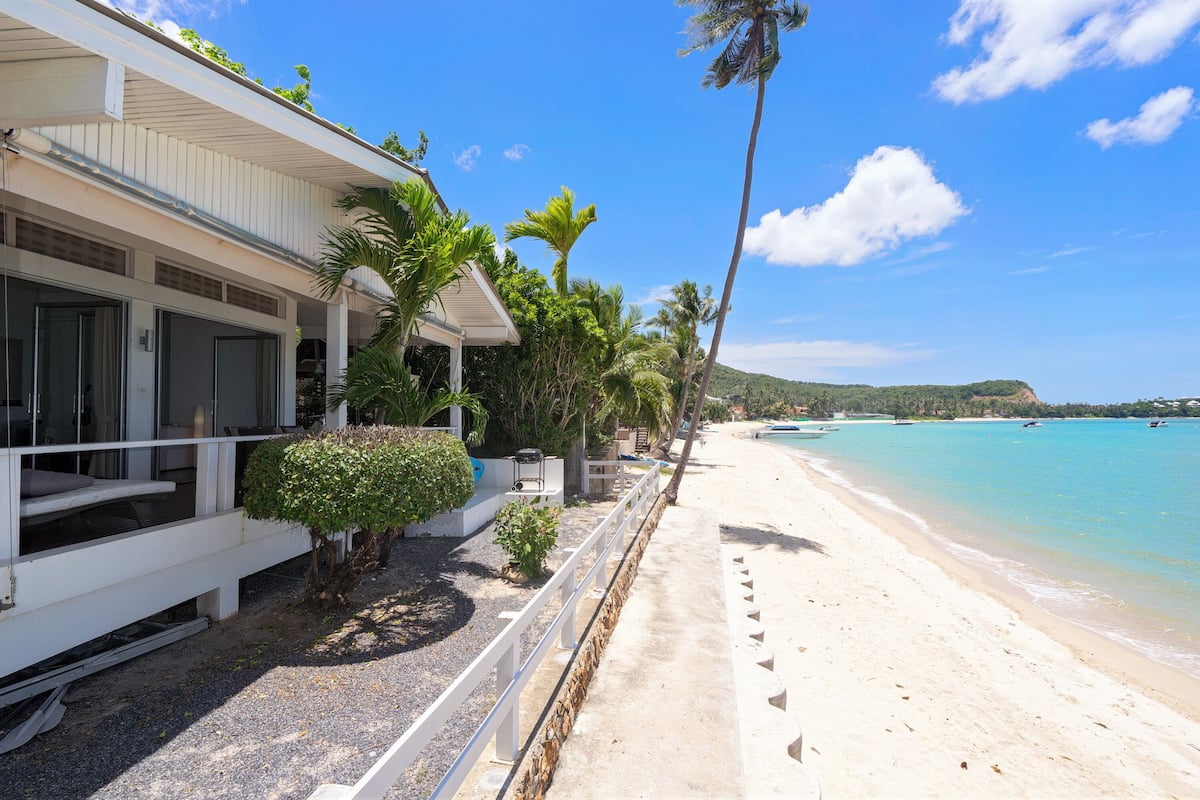 On the beach, white sand, sun loungers, beach umbrellas