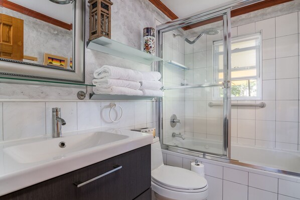 A modern bathroom with a large sink, a toilet, and a glass-enclosed shower. - Experience Massapequa charm near Roosevelt Field Mall, 15 Mins to Jones Beach (Massapequa)