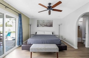 A bedroom with a bed, a ceiling fan, a large window, and a view of the outdoors. - Luxury 5-BR Villa | 3 Master Suites, Pool,Hot Tub (Scottsdale)