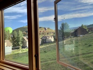 Enjoy breathtaking views of rolling hills and lush greenery from this room's window.
