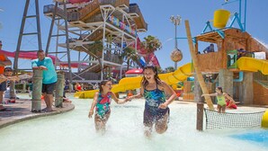 A water park with multiple slides and a wooden structure labeled "SCHLITTERBAUM". - ON THE BEACH  EXCELLENT 5-💎💎💎💎💎 CONDO! Great Rates! 🌴 ⛱️permit: #384879 (South Padre Island)