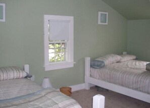 A bedroom with two single beds, a window, and a small bedside table. - FREE 3rd Night!* (See description) Nantucket in Town 3 Bedroom 1 Bath Cute House (Nantucket)