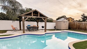 A backyard with a swimming pool, a wooden gazebo, and a barbecue grill. - Affordable 3 Bedroom Home W / Private Pool. Minutes from Orlando's theme parks (Orlando)