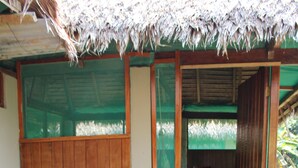 A wooden staircase leading to a room with a thatched roof and wooden walls. - Paradise Amazon Lodge & Adventure (Tambopata)