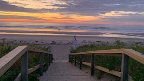 A wooden staircase leading to a beach with a sunset in the background. - Relax and get away! Beautiful beach house, close to OGT Village and Beach  (Ogunquit)