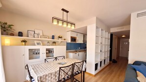 A compact living space with a dining area, kitchenette, and a seating area with a sofa. - Al 318 - Penthouse with terrace  near the beach (Vera playa)