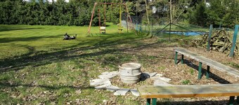 Apartment near the forest with a large garden with playground and fire pit