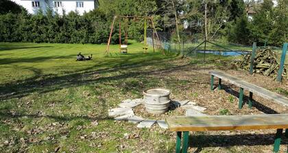 Apartment near the forest with a large garden with playground and fire pit