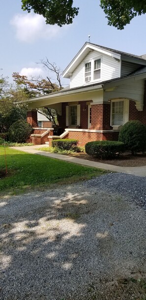 Front of home with large porch and key pad for easy entry